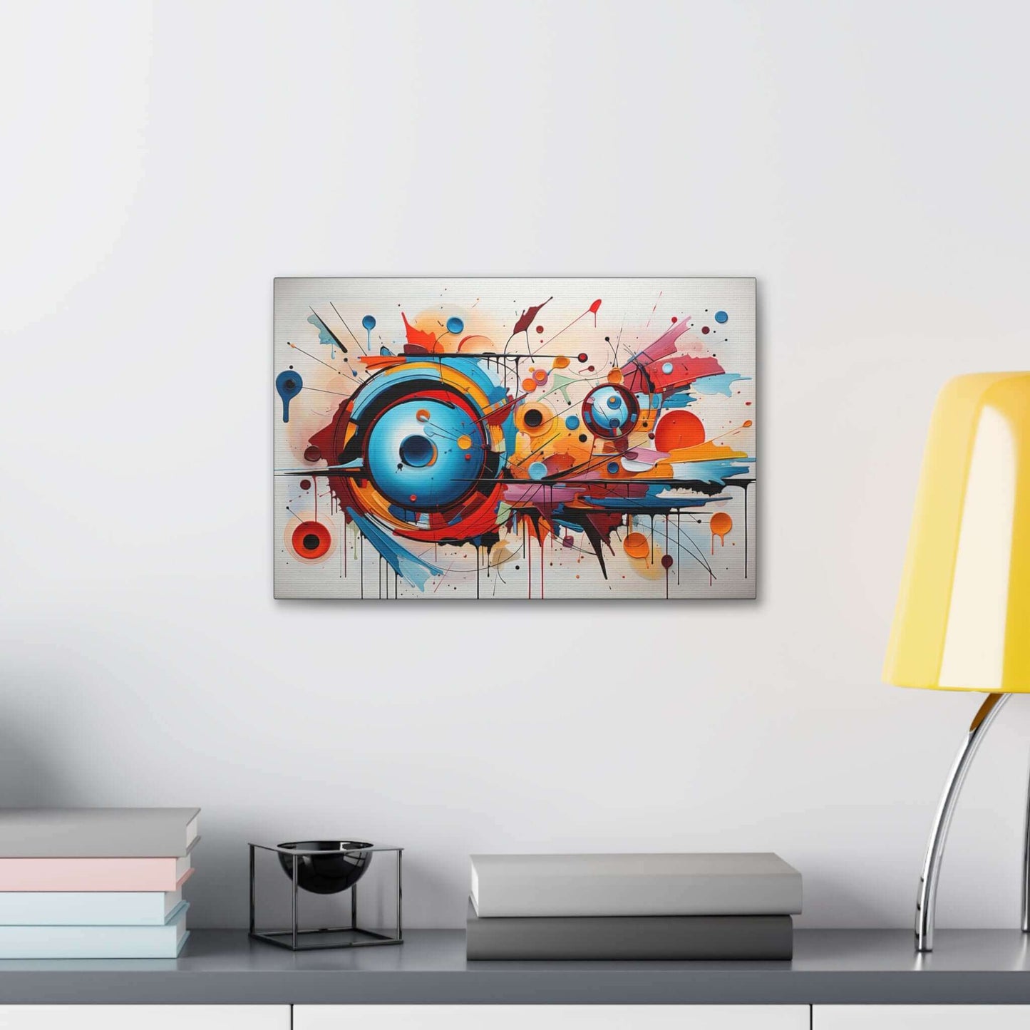 The Dynamic Graffiti Sphere Canvas Wall Art by Printify, titled "Abstract Spherical Explosion with Colorful Splashes," features an abstract expressionism painting with a dynamic composition. Circular forms in vibrant shades of blue, orange, and red dominate the center, surrounded by energetic splashes and drips of paint. This large-format piece creates a compelling sense of movement on a white background.
