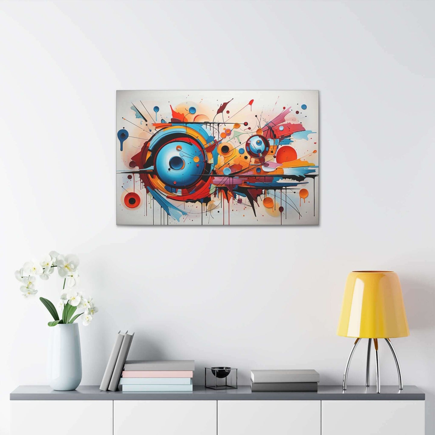 The Dynamic Graffiti Sphere Canvas Wall Art by Printify, titled "Abstract Spherical Explosion with Colorful Splashes," features an abstract expressionism painting with a dynamic composition. Circular forms in vibrant shades of blue, orange, and red dominate the center, surrounded by energetic splashes and drips of paint. This large-format piece creates a compelling sense of movement on a white background.