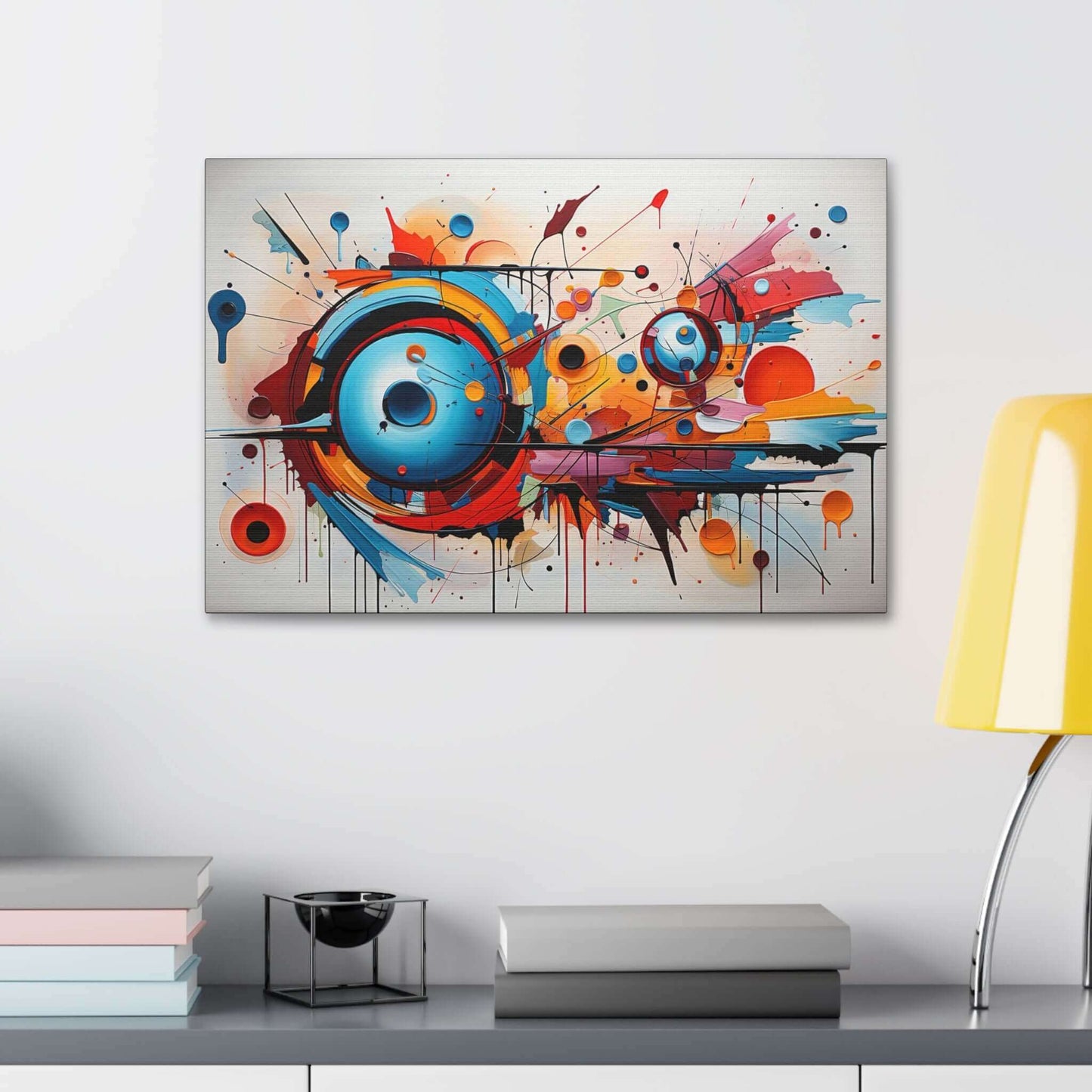 The Dynamic Graffiti Sphere Canvas Wall Art by Printify, titled "Abstract Spherical Explosion with Colorful Splashes," features an abstract expressionism painting with a dynamic composition. Circular forms in vibrant shades of blue, orange, and red dominate the center, surrounded by energetic splashes and drips of paint. This large-format piece creates a compelling sense of movement on a white background.