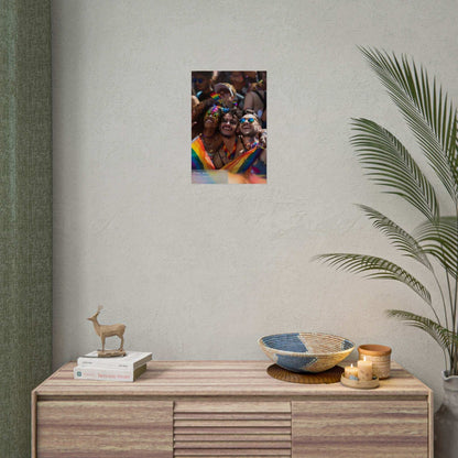 Poster of joyous friends adorned in rainbow accessories, celebrating chosen family unity during Pride, displayed on a modern wall.