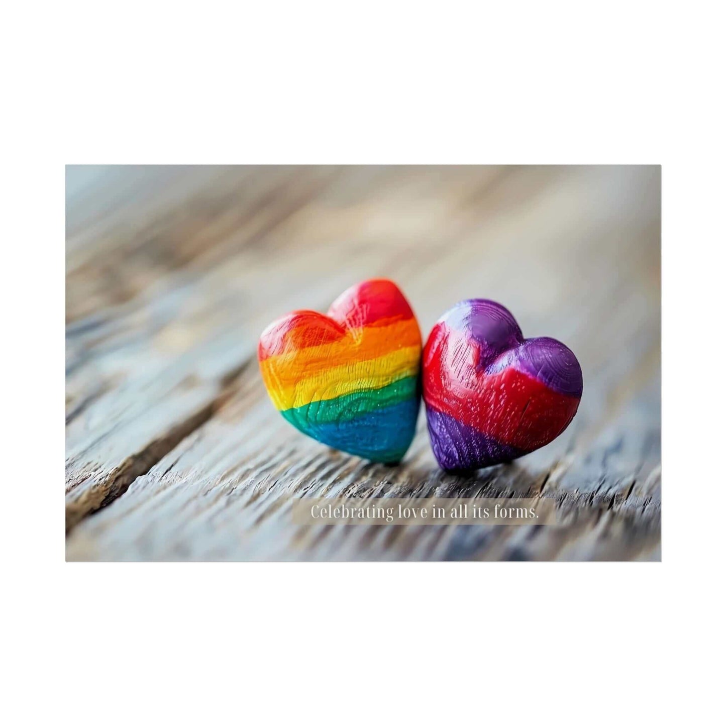 Two small wooden hearts on a wooden surface. The left heart is painted with rainbow colors, and the right heart has a gradient mix of red, purple, and blue. Below the hearts is the text "Celebrating love in all its forms," embracing pride and diversity. This artwork perfectly captures the essence of Printify's "Love in All Forms: Beautiful Gay Pride Poster Wall Art, Inspired by Heartfelt 6-Word Story | PR-6W-007p.