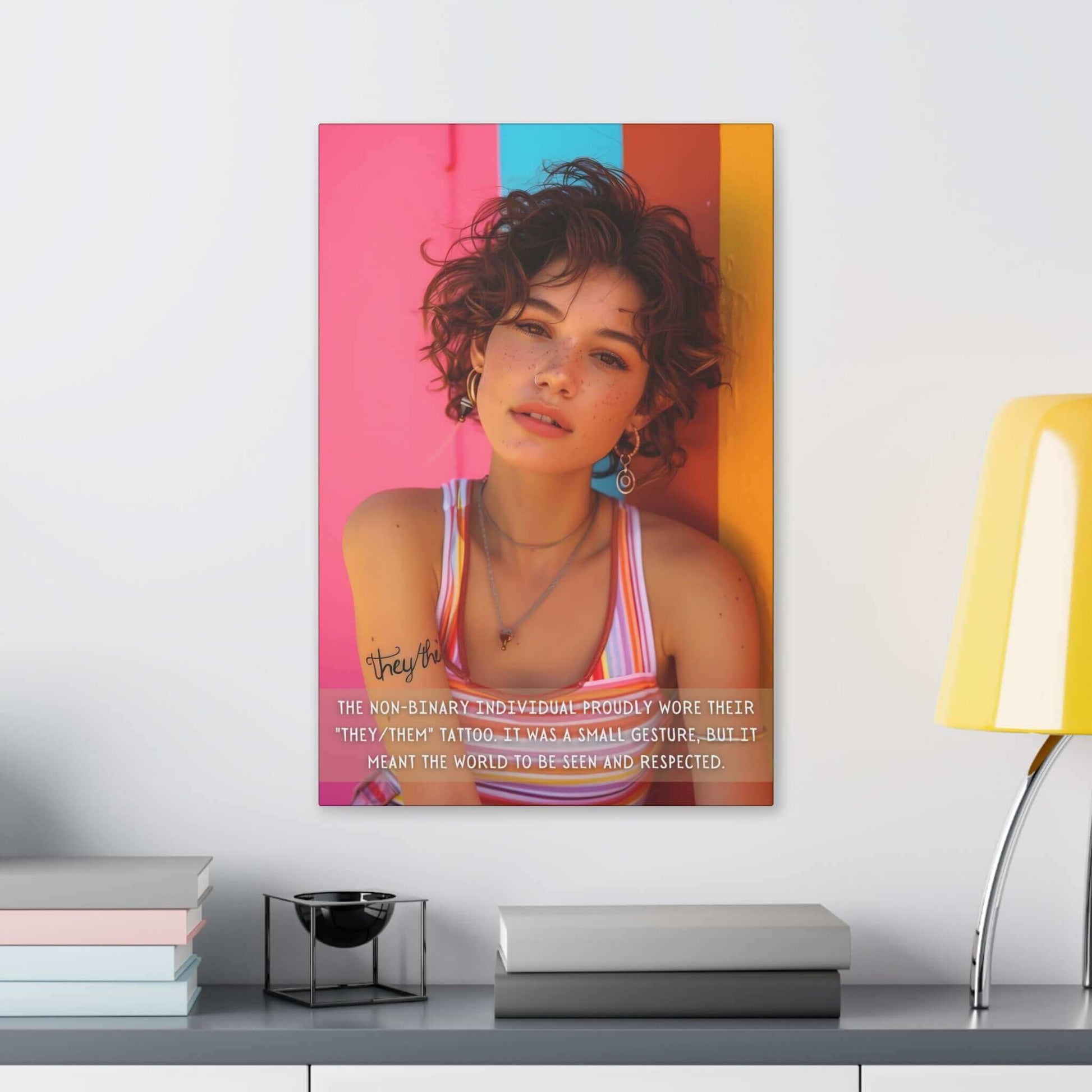 A young person with curly hair, wearing a striped tank top and earrings, stands against a vibrant, colorful wall adorned with the "They/Them: Bold Gay Pride Canvas Wall Art" by Printify. A text overlay reads, "The non-binary individual proudly wore their 'they/them' tattoo. It was a small gesture of self-expression, but it meant the world to be seen and respected.