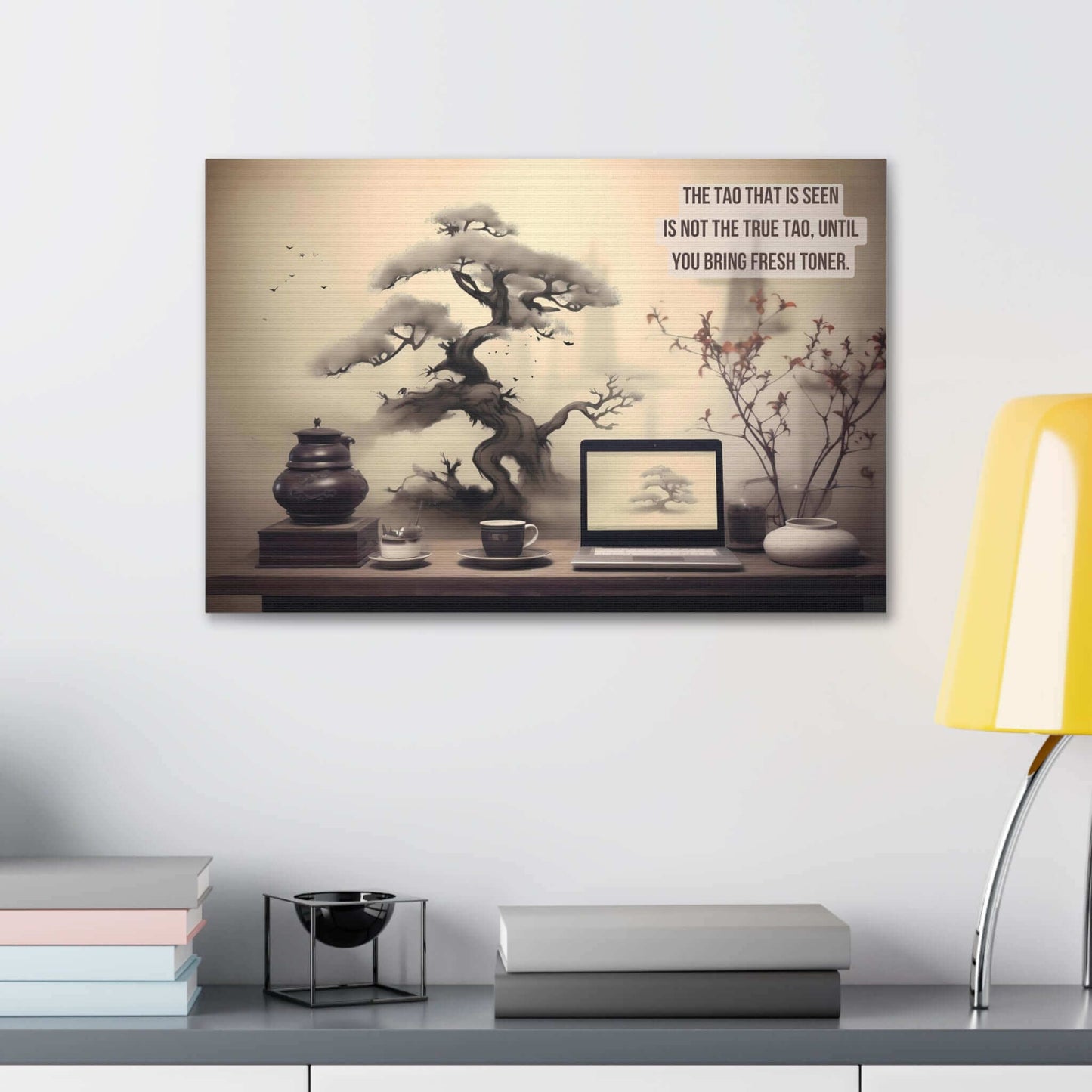 The Asian-Inspired Canvas Wall Art by Printify showcases a tranquil scene featuring a bonsai tree, a black teapot, and a brown mug next to a laptop displaying another bonsai image. The background reflects Taoist philosophy with the clever haiku: "The Tao that is seen is not the true Tao, until you bring fresh toner." A yellow lamp stands to the right.