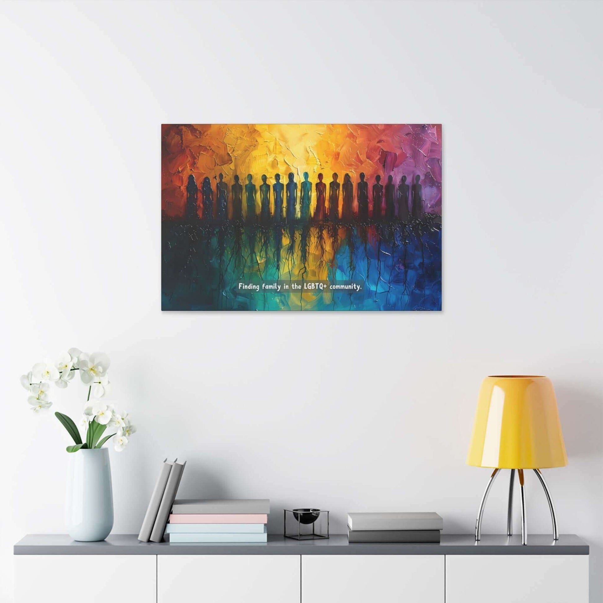 A vivid canvas from Printify, titled "Roots of Pride: Inspiring Gay Pride Canvas Wall Art," depicts a diverse group of silhouetted figures standing in a row. The background transitions seamlessly from warm oranges and yellows to cool blues, reflecting the figures below. Text reads: "Finding unity and pride in the LGBTQ+ community.