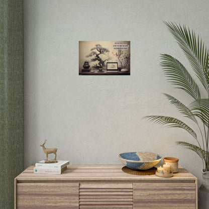 A workspace includes a laptop, a cup, a teapot, a stack of books, and a plant. An Asian-Inspired Poster Wall Art with Bonsai & Clever Haiku by Printify blends seamlessly with the real objects. The humorous Asian-themed text reads, "The Tao that is seen is not the true Tao, until you bring fresh toner.