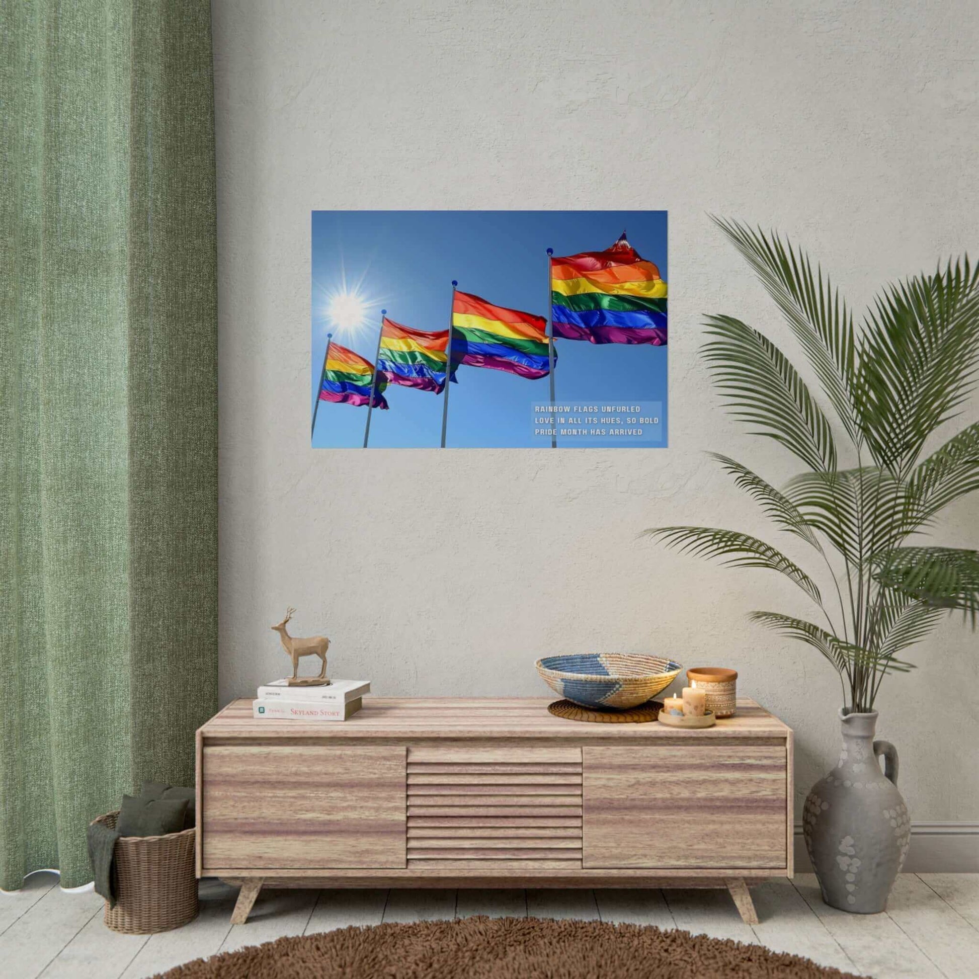 Four **Bold Rainbow Flags Poster Wall Art** wave in the breeze under a clear blue sky with the sun shining brightly. The text overlay reads, "Rainbow flags unfurled, Love in all its hues, so bold," celebrating Pride Month for the LGBTQ+ community. Created by **Printify**, this inspired piece of decor is perfect for commemorating Pride Month.