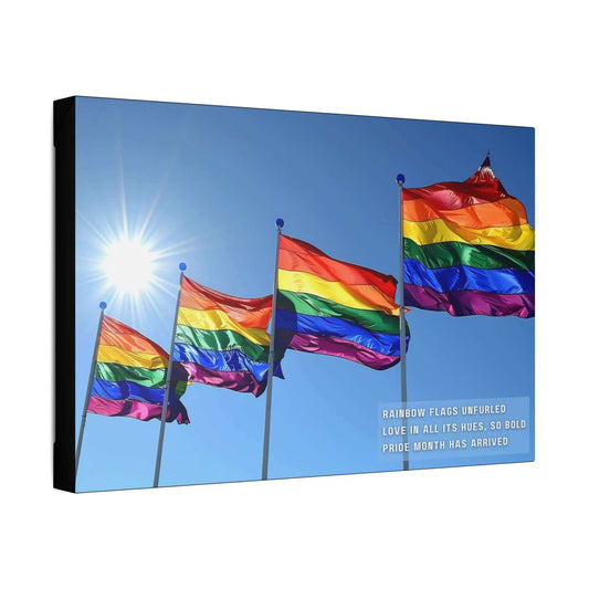 A collection of Bold Rainbow Flags Canvas Wall Art from Printify is shown flying in the breeze against a clear blue sky, with sunlight shining brightly in the background. The text on the vibrant Pride Month Art Print reads, "RAINBOW FLAGS UNFURLED LOVE IN ALL ITS HUES, SO BOLD PRIDE MONTH HAS ARRIVED," celebrating the LGBTQ+ community.