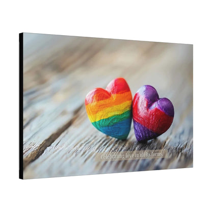 Two heart-shaped stones rest on a wooden surface. One heart features vibrant rainbow colors, while the other displays enchanting shades of purple. Overlayed text reads, "Celebrating love in all its forms." The image emanates a message of love and inclusivity, honoring diverse love within the LGBTQ+ community with Printify's "Love in All Forms: Beautiful Gay Pride Canvas Wall Art, Inspired by Heartfelt 6-Word Story | PR-6W-007c.