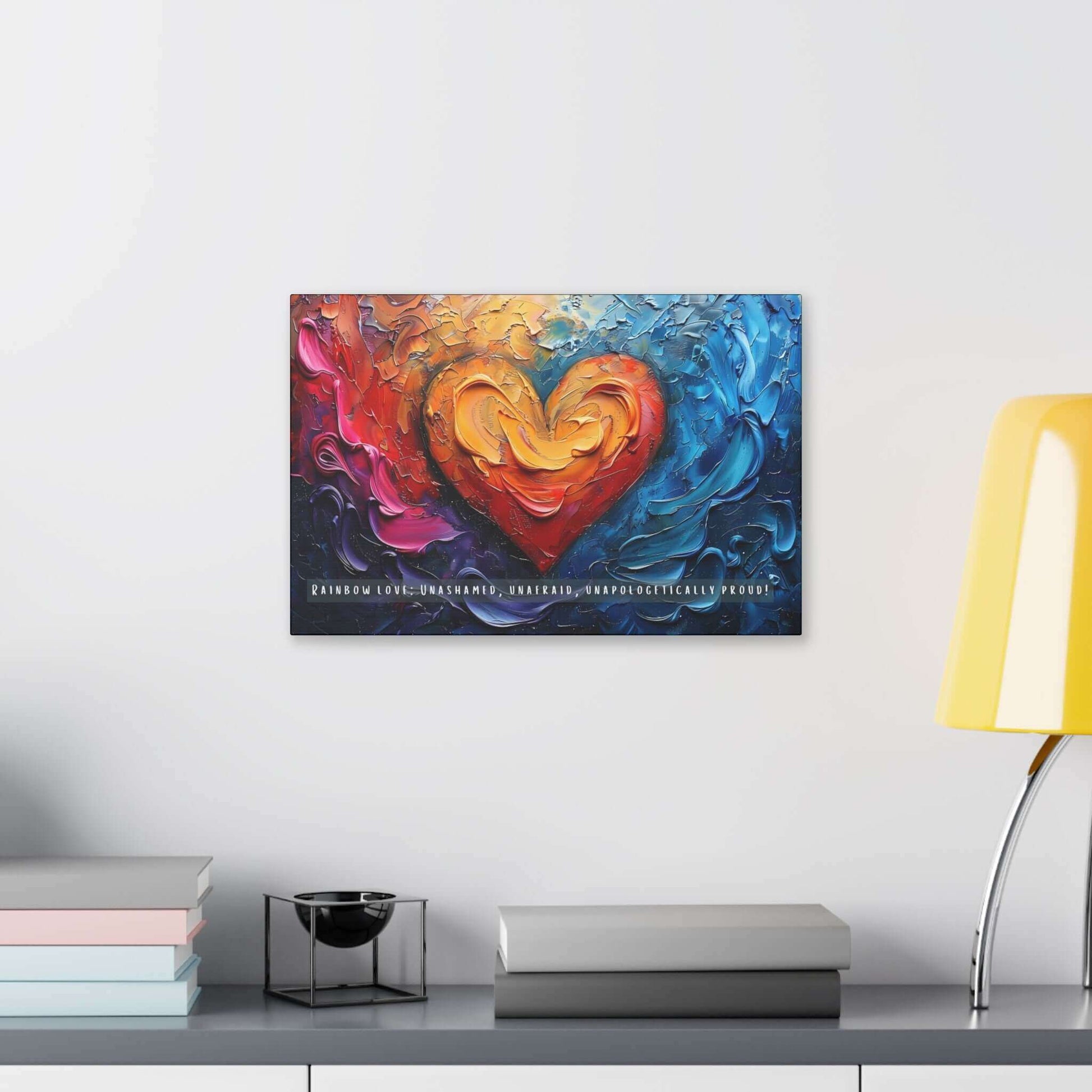 The Rainbow Love: Bold Gay Pride Canvas Wall Art by Printify (PR-6W-004c) features a vividly colorful painting with a heart at the center, surrounded by swirling abstract patterns in shades of red, orange, yellow, blue, and purple. At the bottom, it proudly displays the text: “RAINBOW LOVE: UNASHAMED, UNAFRAID, UNAPOLOGETICALLY PROUD!”—a vibrant celebration of diversity and pride within the LGBTQ+ community.