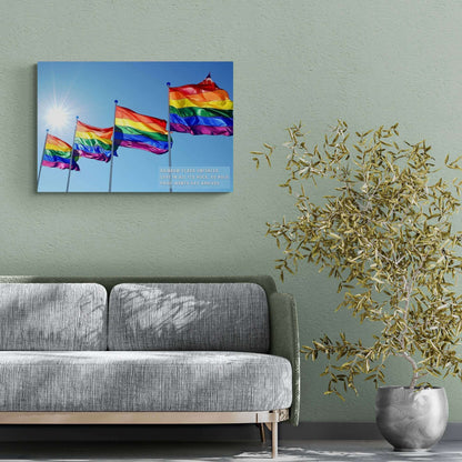 Four **Bold Rainbow Flags Poster Wall Art** wave in the breeze under a clear blue sky with the sun shining brightly. The text overlay reads, "Rainbow flags unfurled, Love in all its hues, so bold," celebrating Pride Month for the LGBTQ+ community. Created by **Printify**, this inspired piece of decor is perfect for commemorating Pride Month.